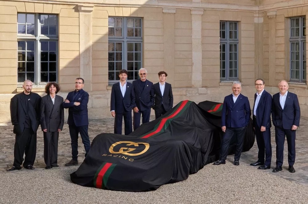 Gucci Racing Alpine car covered in Gucci Racing drape with team and drivers Paris 2026