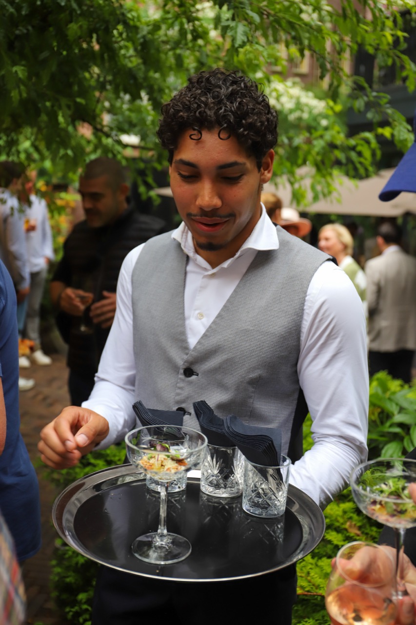 Waiter serving at the garden party