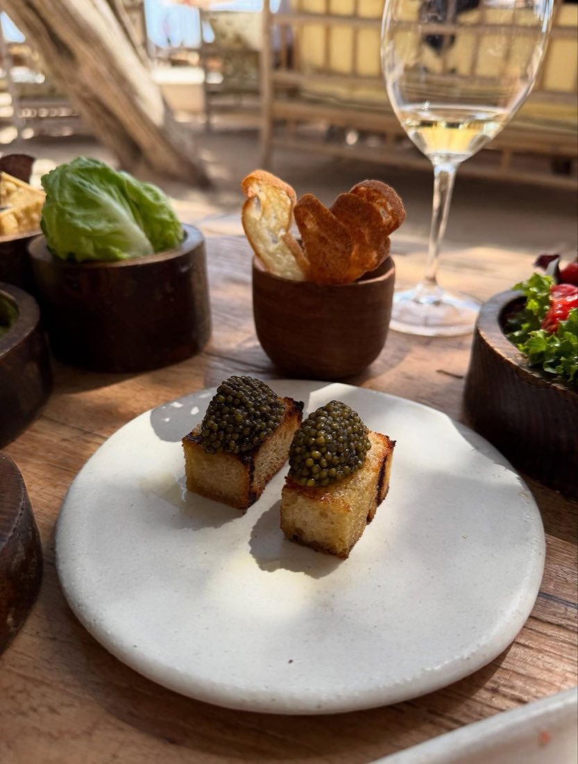 Caviar toast served on a plate at a beach club table in Ibiza