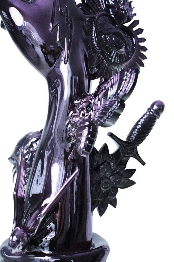 Detail of Vliegwork's Five Finger Scrapbook sculpture showing eye, wings and dagger motifs