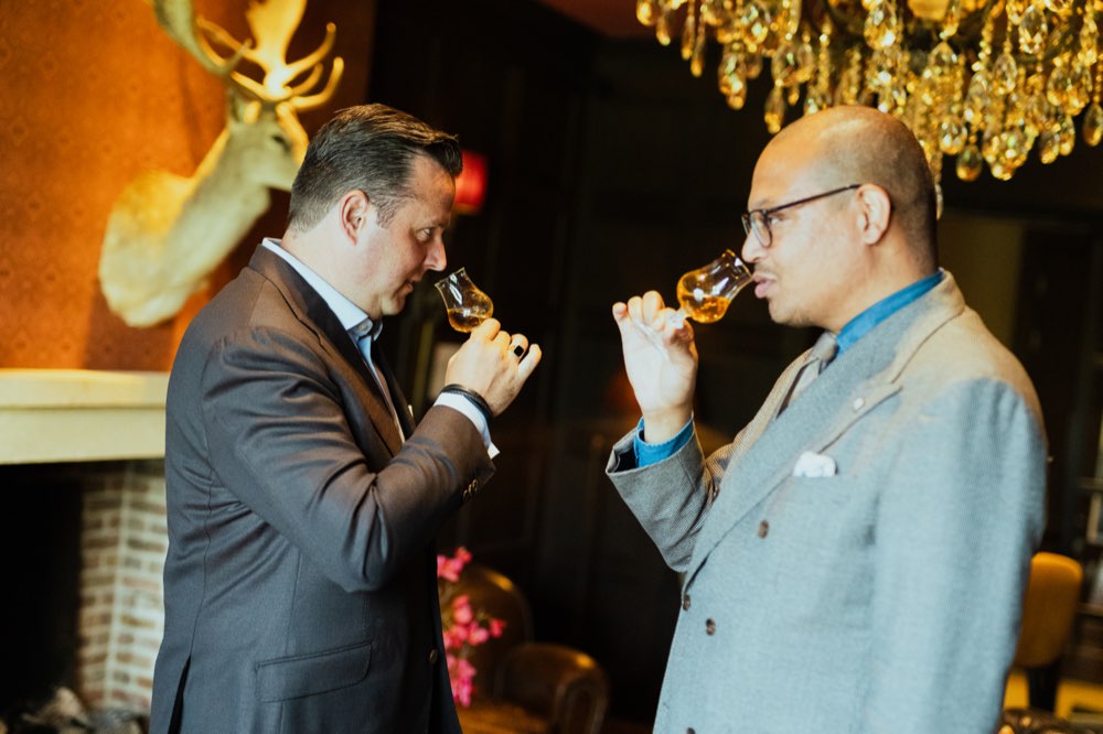 Two men tasting whisky from Glencairn glasses at a private WWS tasting event